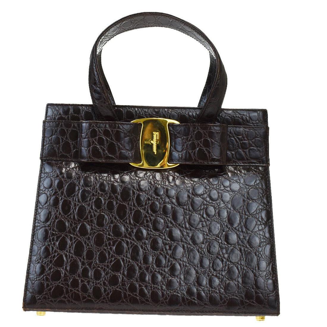 Authentic SALVATORE FERRAGAMO Leather Hand bag: Brand: SALVATORE FERRAGAMO Material: Leather Style: Hand bag Color: Brown Size(inch): W 9.4 x H 7.9 x D 0.8 "(approx.) Country of Origin: Italy Come with: - All Bidhaus items come with a 100% money-ba