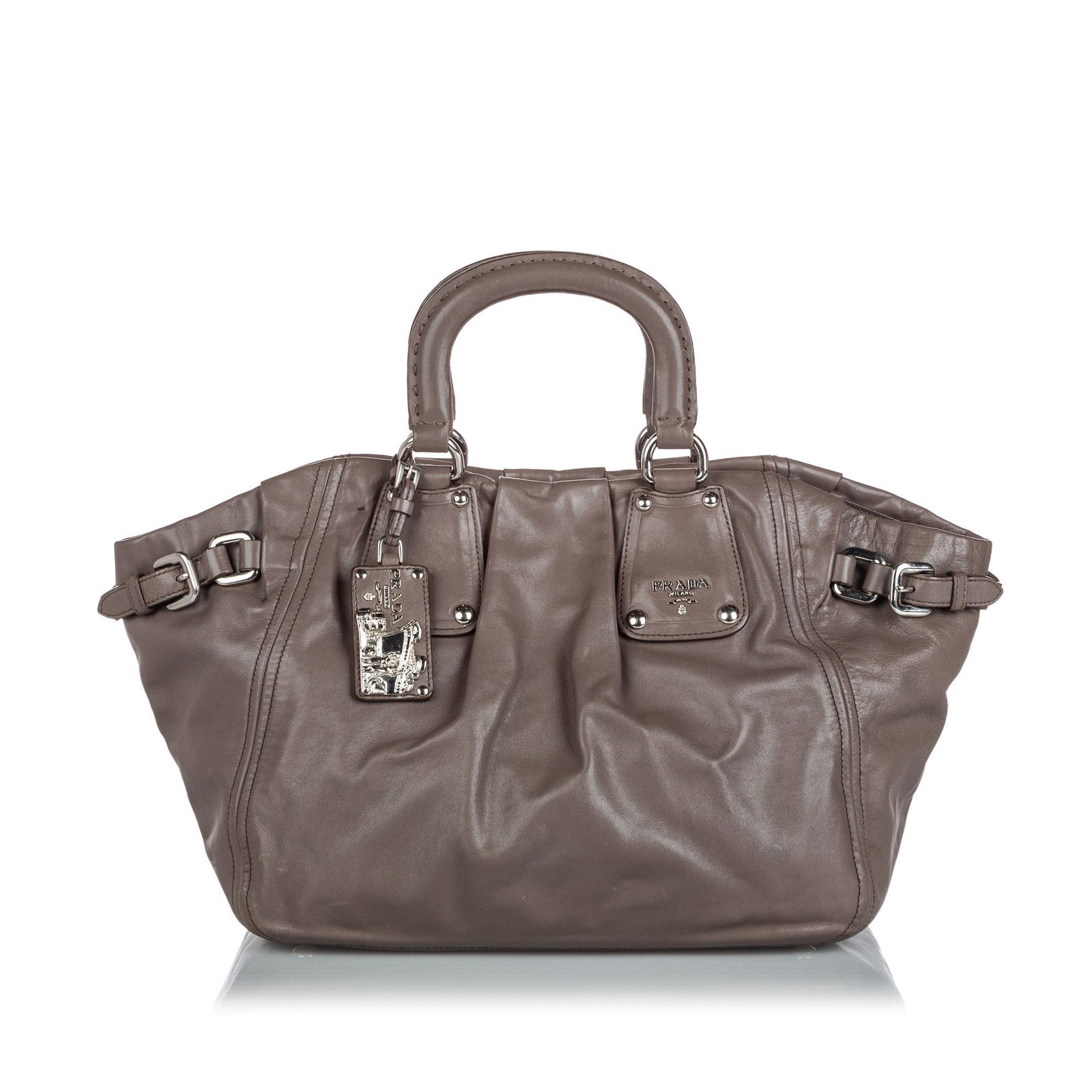 Authentic Prada Leather Satchel: This satchel features a leather body, rolled leather handles, a detachable flat leather strap, an open top with a magnetic closure, and interior zip and slip pockets. Brand: Prada Model: Leather Satch