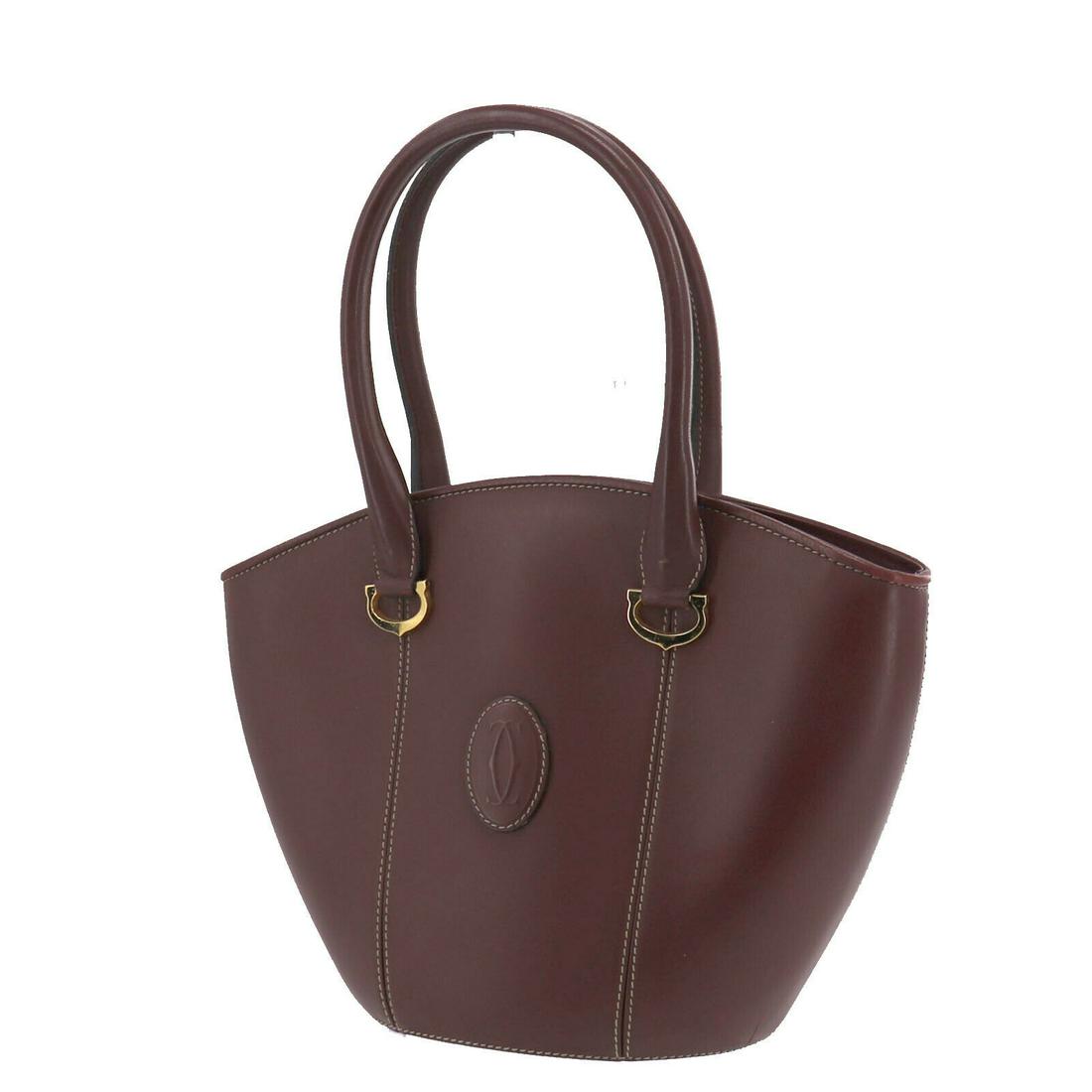 Authentic CARTIER Leather Hand Bag: Brand: CARTIER Material: Leather Style: Hand Bag Color: Bordeaux Size(Inch): H 9.8 x D 4.3 x L 14.1Handle: 20.4 All Bidhaus items come with a 100% money-back authenticity guarantee. ALL SALES ARE FINA
