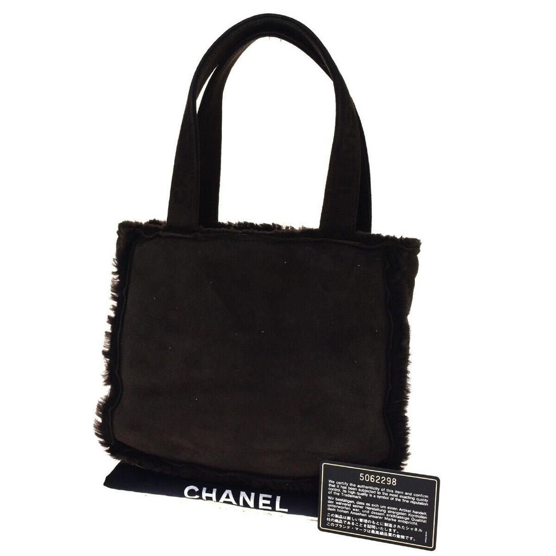Authentic CHANEL Suded Skin Leather Hand Bag: Brand: CHANEL Material: Suded Skin Leather Style: Hand bag Color: Brown Size(inch): W 7.9 x H 7.9 x D 2.4 "(approx.) Country of Origin: France Come with: Authenticity Seal,Authenticity Card All Bidhau