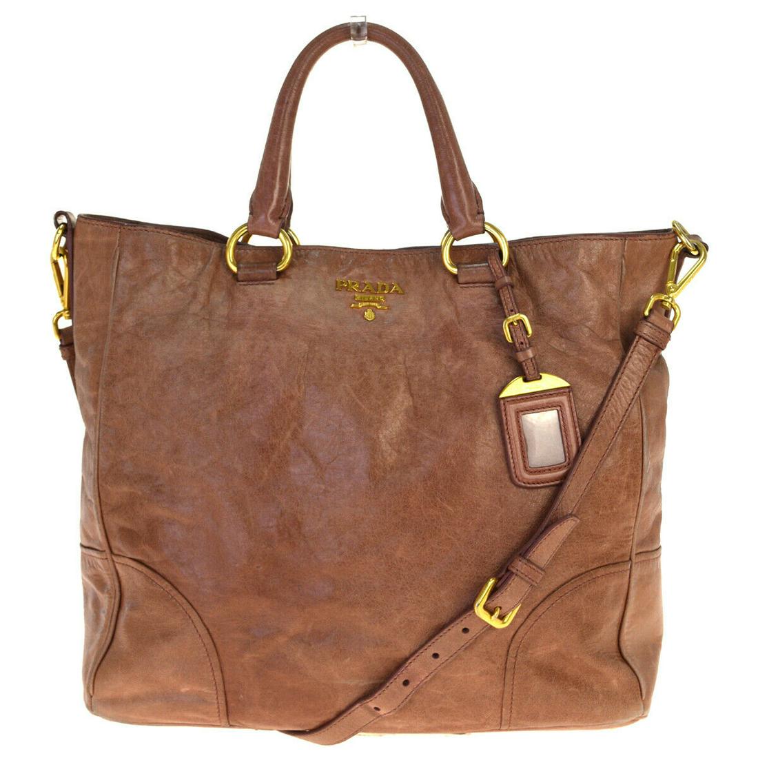 Authentic PRADA Leather Tote hand bag: Brand: PRADA Material: Leather Style: Tote hand bag Color: Pink Size(inch): W 13 x H 12.2 x D 5.5 "(approx.) Country of Origin: China Come with: Shoulder strap,name tag All Bidhaus items come with a 1
