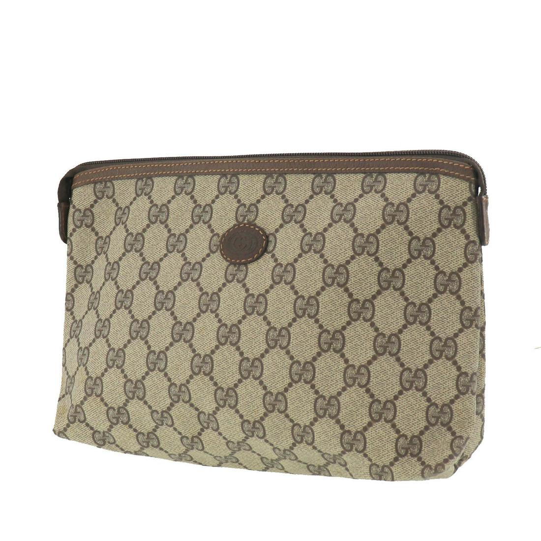 Authentic GUCCI VINTAGE PVC Leather Clutch: Brand: GUCCI Material: PVC Leather Style: Clutch Color: Brown Size(Inch): H 6.6 x D 2.7 x L 10.6 Country of Origin: Italy Come with: - All Bidhaus items come with a 100% money-back authenticity guaran