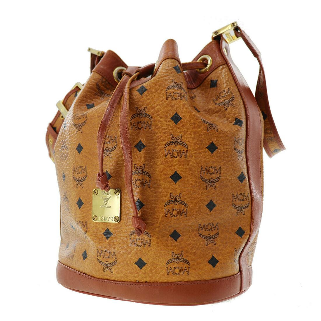 Authentic MCM Coated canvas Shoulder Bag: Brand: MCM Material: Coated canvas Style: Shoulder Bag Color: Brown Size(Inch): H 11.8 x D 6.6 Ã—L 8.6Shoulder. 34.6-44.0 Country of Origin: Germany Come with: PadLock (Missing Key) All Bidhaus ite