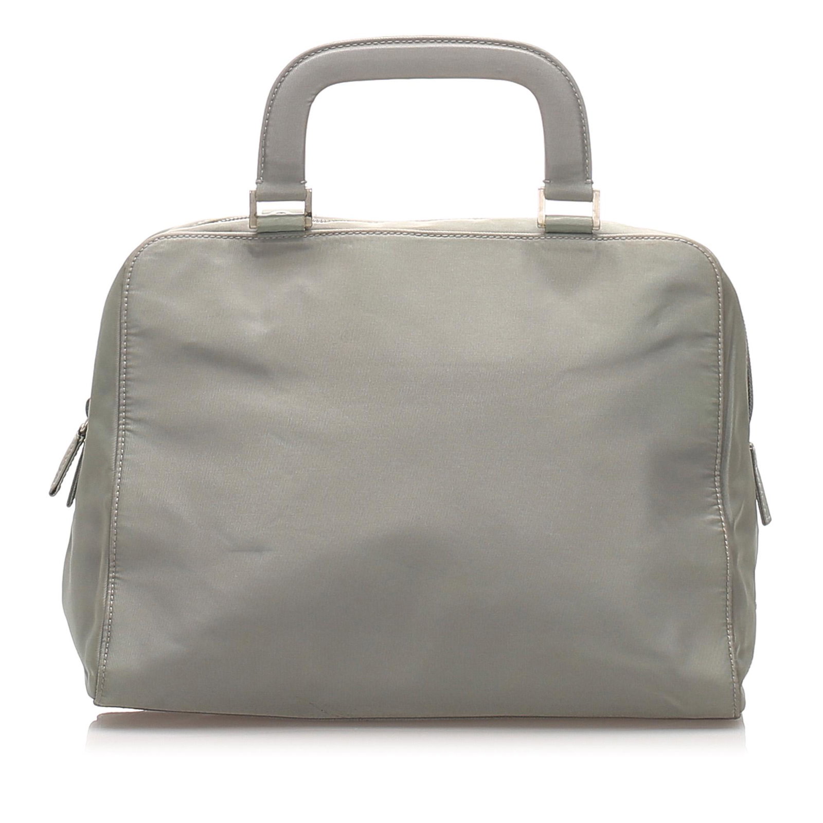 Authentic Prada Tessuto Handbag: This handbag features a nylon body, flat leather handles, a top zip closure, and an interior zip pocket.Brand: Prada Model: Tessuto Handbag Origin: Italy Category: Handbag Color: Gray Style: Tessuto M