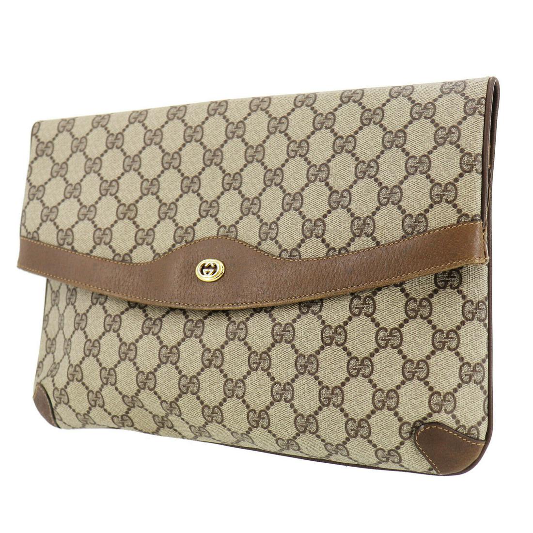 Authentic GUCCI VINTAGE PVC Leather Clutch: Brand: GUCCI Material: PVC Leather Style: Clutch Color: Brown Size(Inch): H 8.2 x D 1.9 x L 12.9 Country of Origin: Italy Come with: - All Bidhaus items come with a 100% money-back authenticity guaran