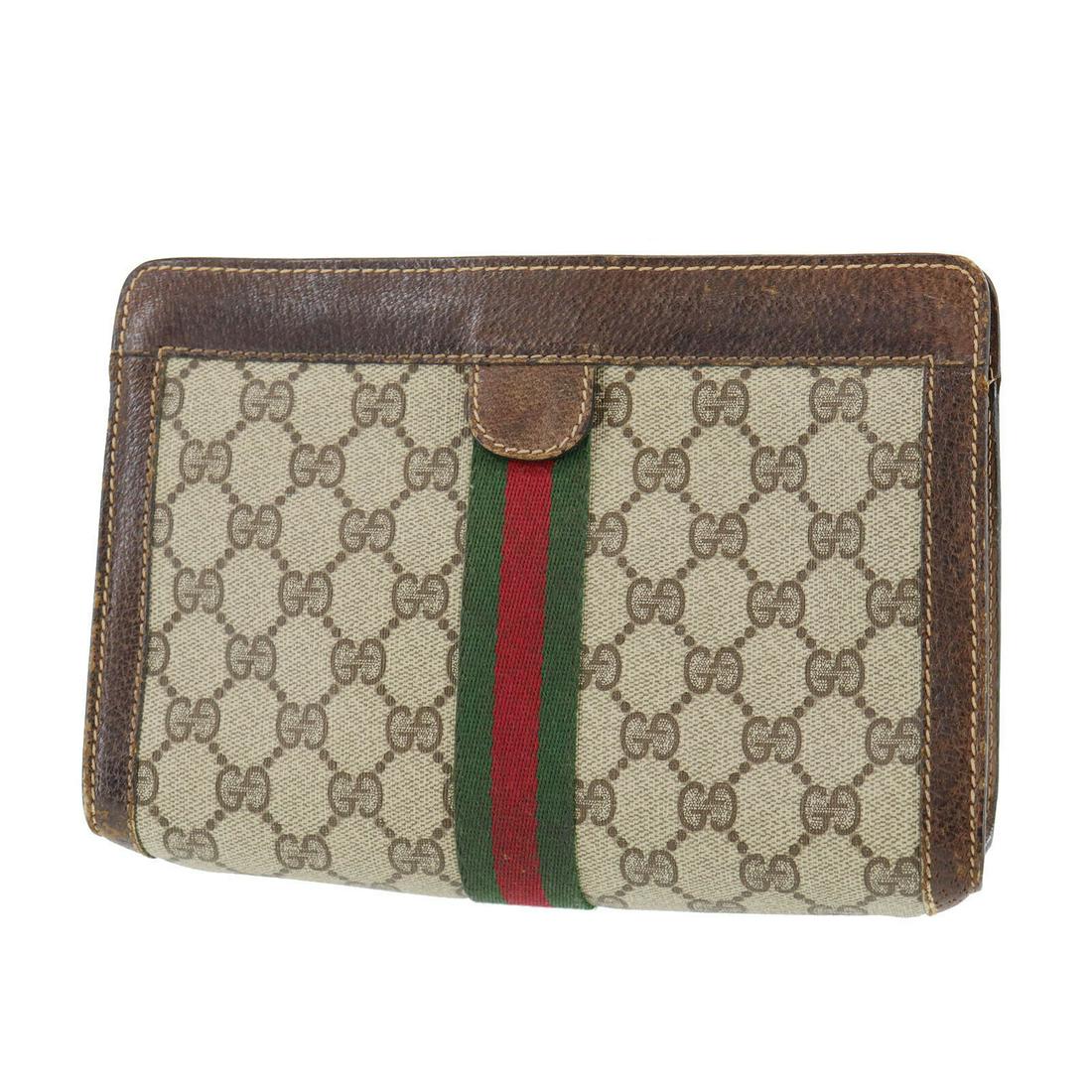 Authentic GUCCI PVCLeather Clutch: Brand: GUCCI Material: PVCLeather Style: Clutch Color: Brown Size(Inch): H 6.2 x D 2.5 x L 8.6 Country of Origin: Italy Come with: - All Bidhaus items come with a 100% money-back authenticity guarante