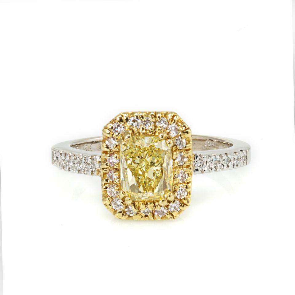 Authentic 1.27 carat Fancy Yellow Radiant Cut Diamond: This ring is handcrafted with a fancy yellow radiant cut diamond in a halo setting. Flanked by white diamonds on the shank this ring looks bigger than what it may seem. Center diamond is a 1.27ct GIA