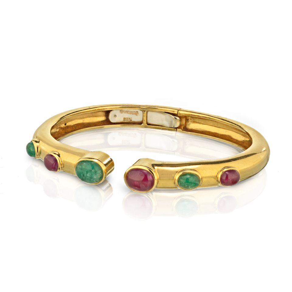 Authentic David Webb 18K Yellow Gold Cabochon Ruby and: Vintage David Webb 18K Gold Cabochon Ruby and Emerald Bangle Bracelet. The hinged bangle features 6 oval-shaped ruby and emerald cabochons set in 18k gold marked Webb. Gross weight 51.3 grams. DIMENSI