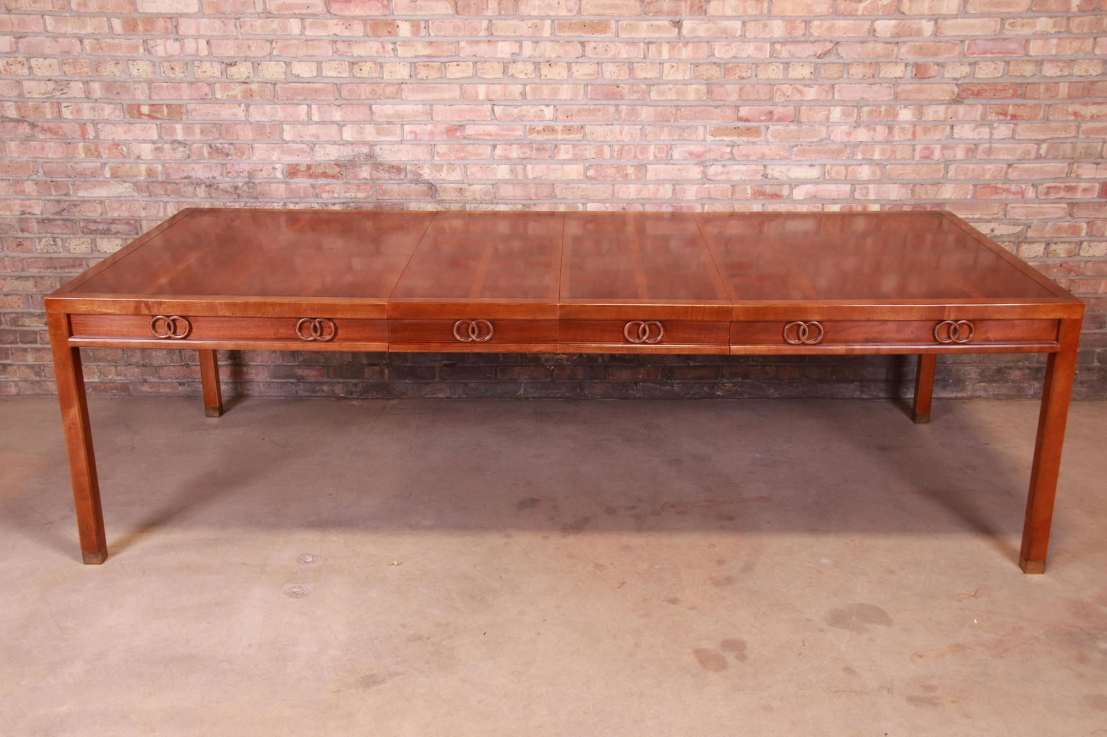 Authentic Michael Taylor for Baker Far East Collection: An exceptional mid-century modern Hollywood Regency Chinoiserie extension dining table By Michael Taylor for Baker Furniture "Far East Collection" USA Mid-20th Century Book-matched walnut with Taylor'