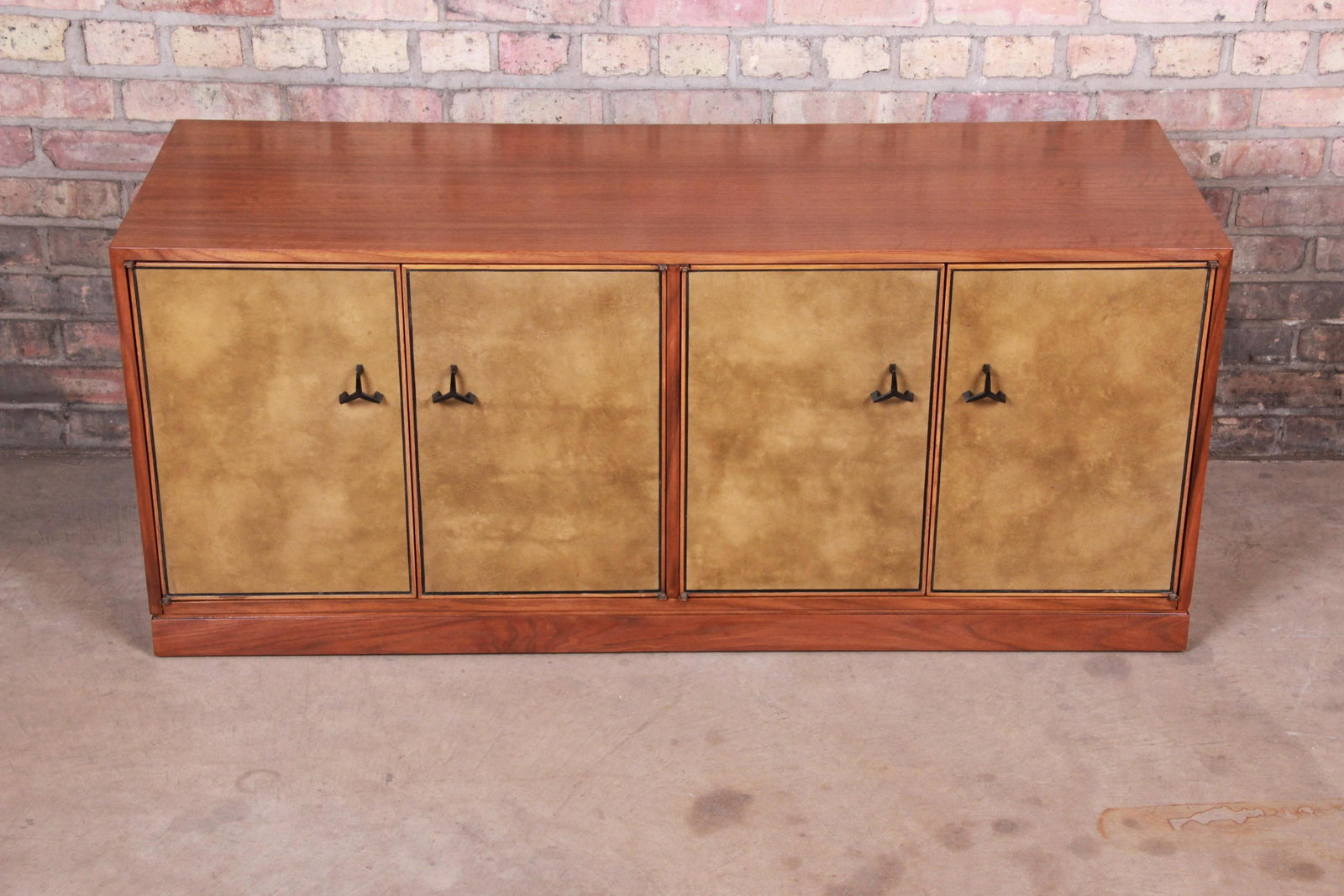 Authentic Edward Wormley for Dunbar Mahogany Low: An exceptional mid-century modern low credenza media cabinet or bar cabinet Attributed to Edward Wormley for Dunbar USA Circa 1940s Mahogany case with leather front. Measures: 49.5"W x 18"D x 20.88"H.
