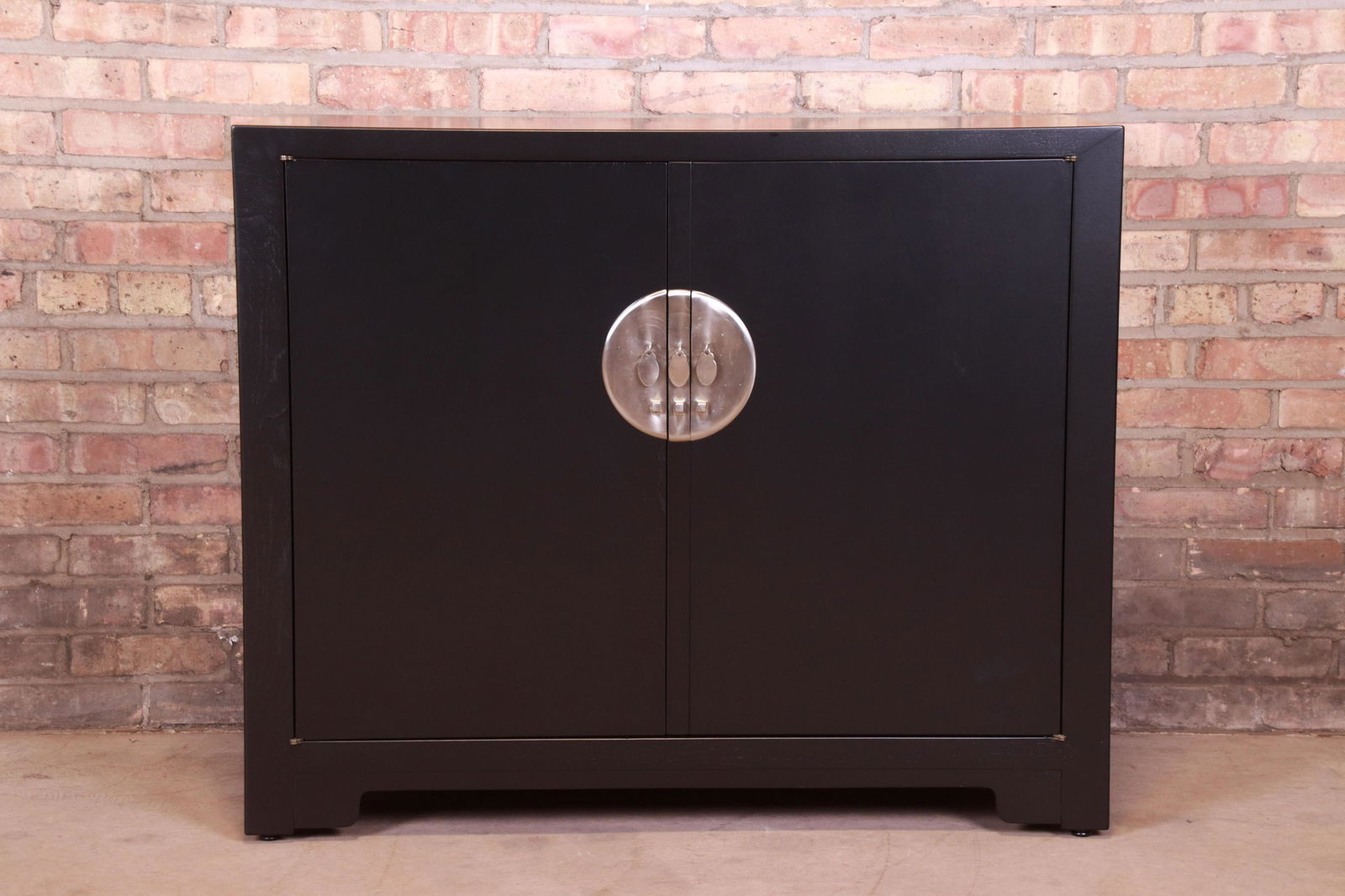 Authentic Michael Taylor for Baker Far East Collection: An exceptional mid-century modern Hollywood Regency Chinoiserie compact credenza sideboard buffet or bar cabinet By Michael Taylor for Baker Furniture "Far East Collection" USA 1950s Black lacquered w