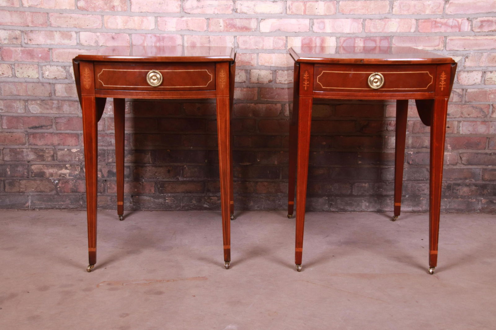 Authentic Baker Furniture Historic Charleston Mahogany: A gorgeous pair of Sheraton style Pembroke nightstands or tea tables By Baker Furniture "Historic Charleston Collection" USA Circa 1980s Mahogany with satinwood banding and inlay and original brass ha