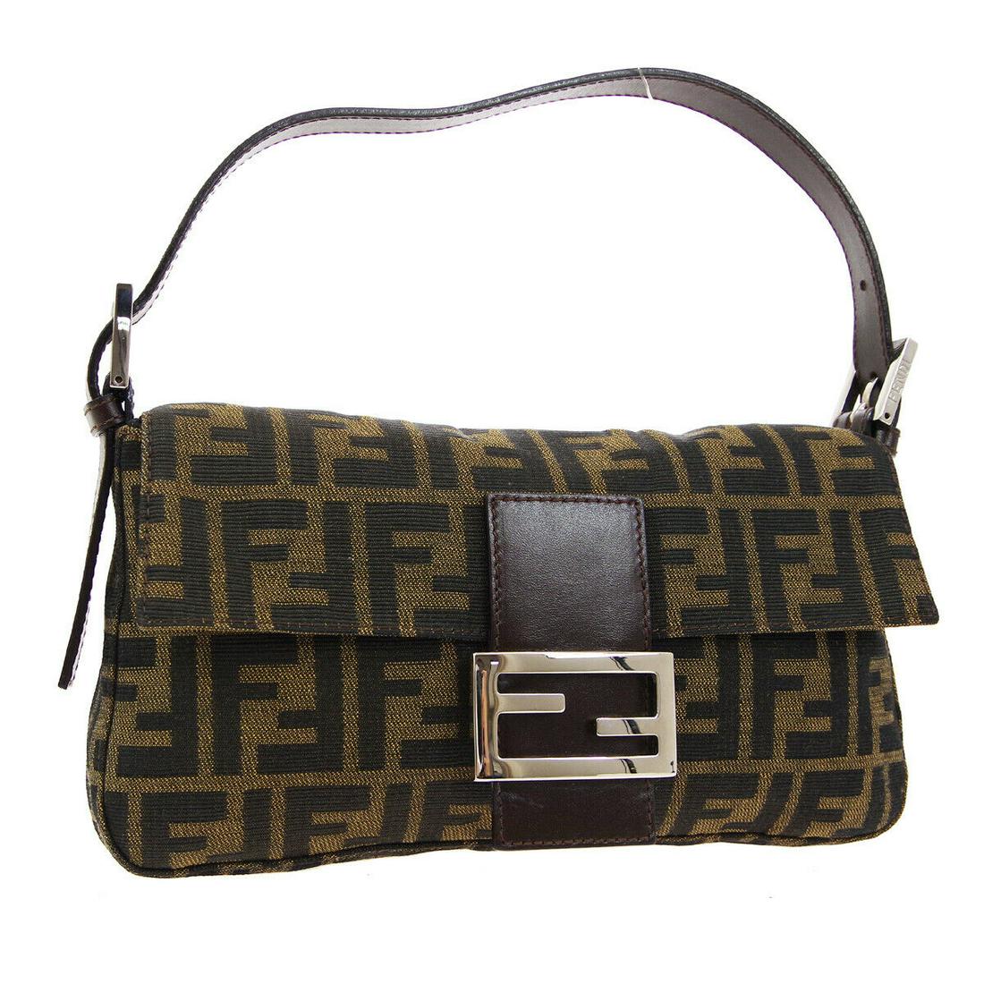 Authentic FENDI Zucca Top Handle: Brand: FENDI Model: Zucca Top Handle Country of Origin: Italy Material: Canvas Color: Brown Size (Inch): W 9.8 x H 5.9 x D 1.8 " Strap Drop. 4.7 - 7.1 " Size (CM): W 25.0 x H 15.0 x D 4.5 cm Strap Dro