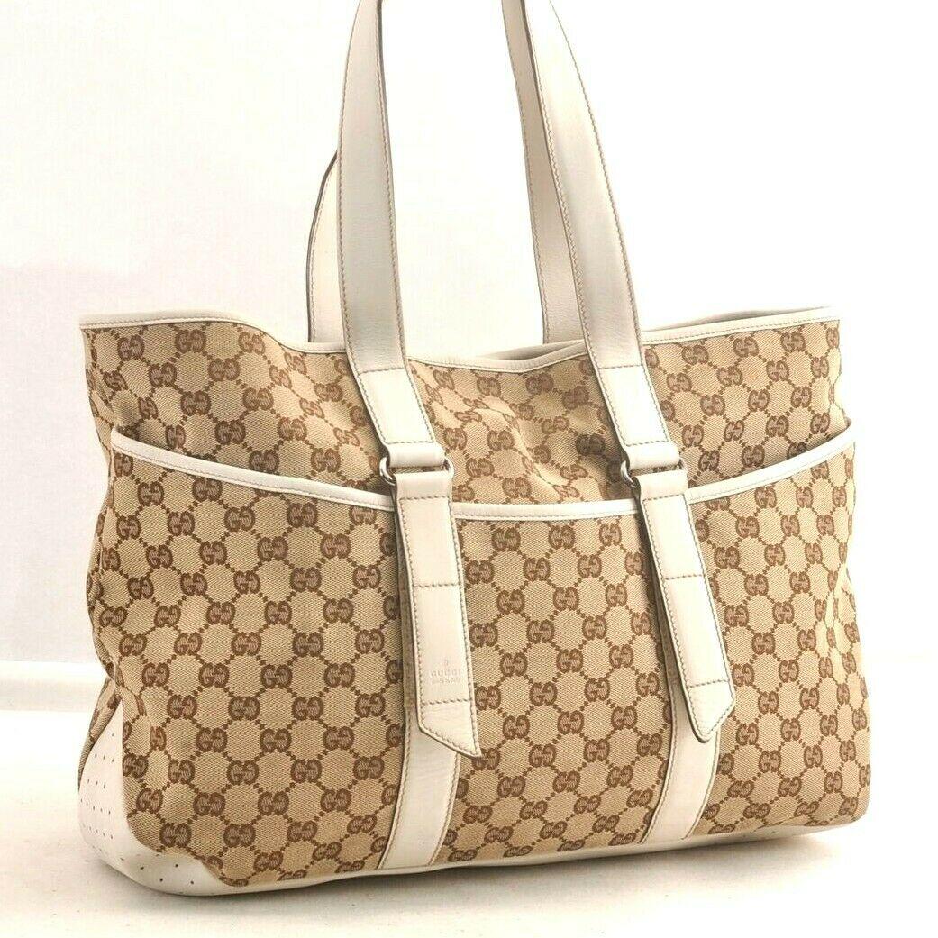 Authentic GUCCI Tote Bag: Brand: GUCCI Model: Tote Bag Country of Origin: Italy Material: Canvas Color: Brown Bag Length: 16.1inches (41cm) Bag Height: 11inches (28cm) Bag Depth: 3.9inches (10cm) All Bidhaus items come with a 