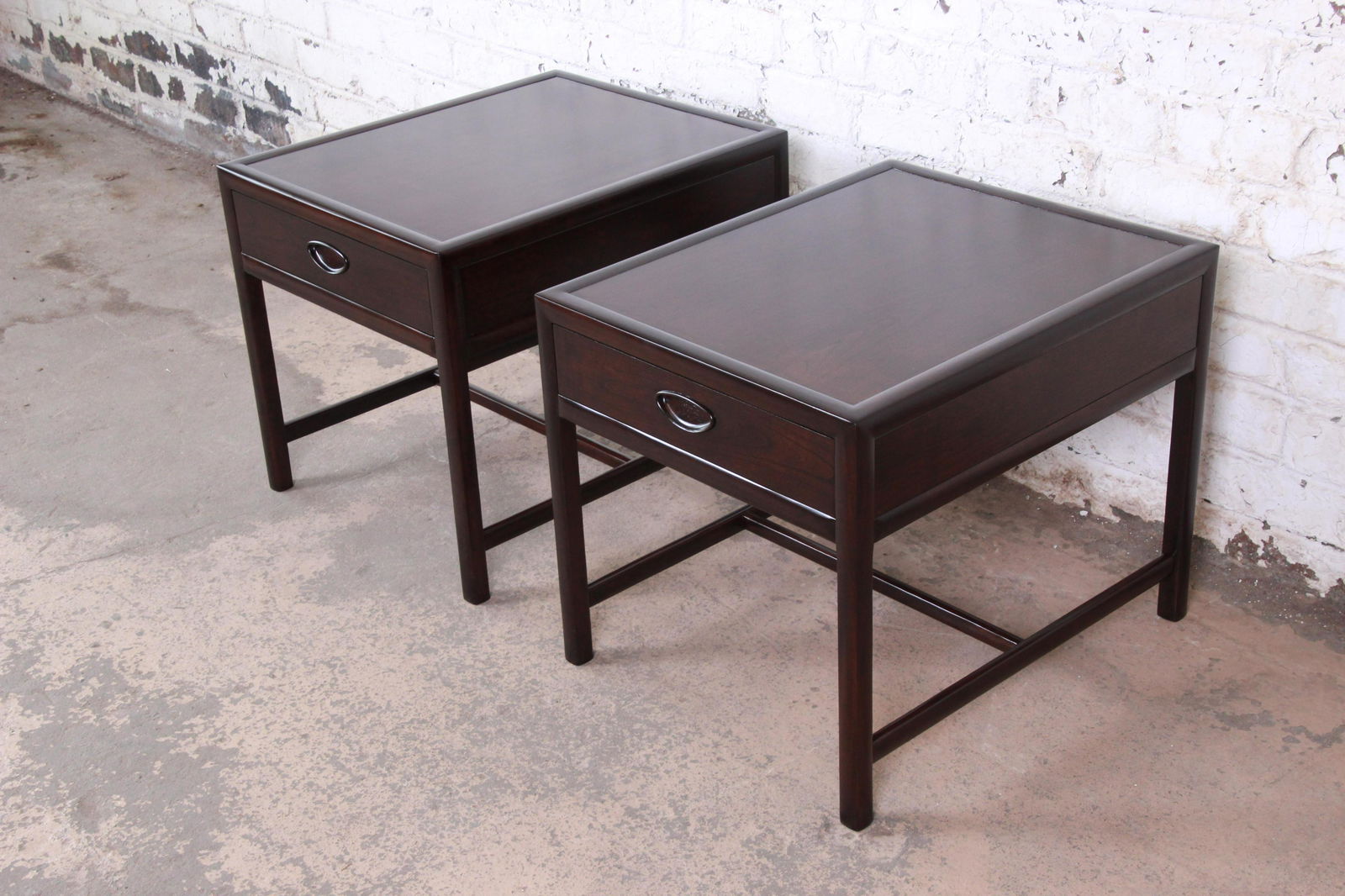 Authentic Michael Taylor for Baker Dark Cherry: An exceptional pair of mid-century modern dark cherry nightstands Designed by Michael Taylor for his "New World" collection for Baker Furniture USA 1950s Measures: 22.13"W x 27"D x 22.13"H. Expertly r