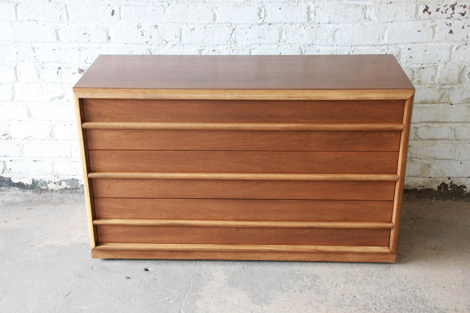 Authentic Robsjohn Gibbings for Widdicomb Mid-Century: Offering a very nice newly refinished three drawer dresser by T.H. Robsjohn Gibbings for Widdicomb. The dresser has a nice walnut wood grain with sculpted drawer pulls in the distinct Gibbings design.