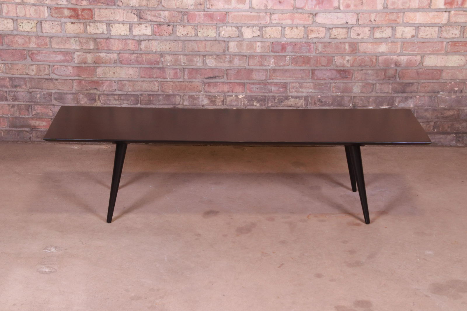 Authentic Paul McCobb Planner Group Black Lacquered: A sleek and stylish mid-century modern black lacquered solid maple coffee table By Paul McCobb for Winchendon Furniture "Planner Group" USA 1950s Measures: 60"W x 18"D x 14.88"H. Newly refinished. Exc