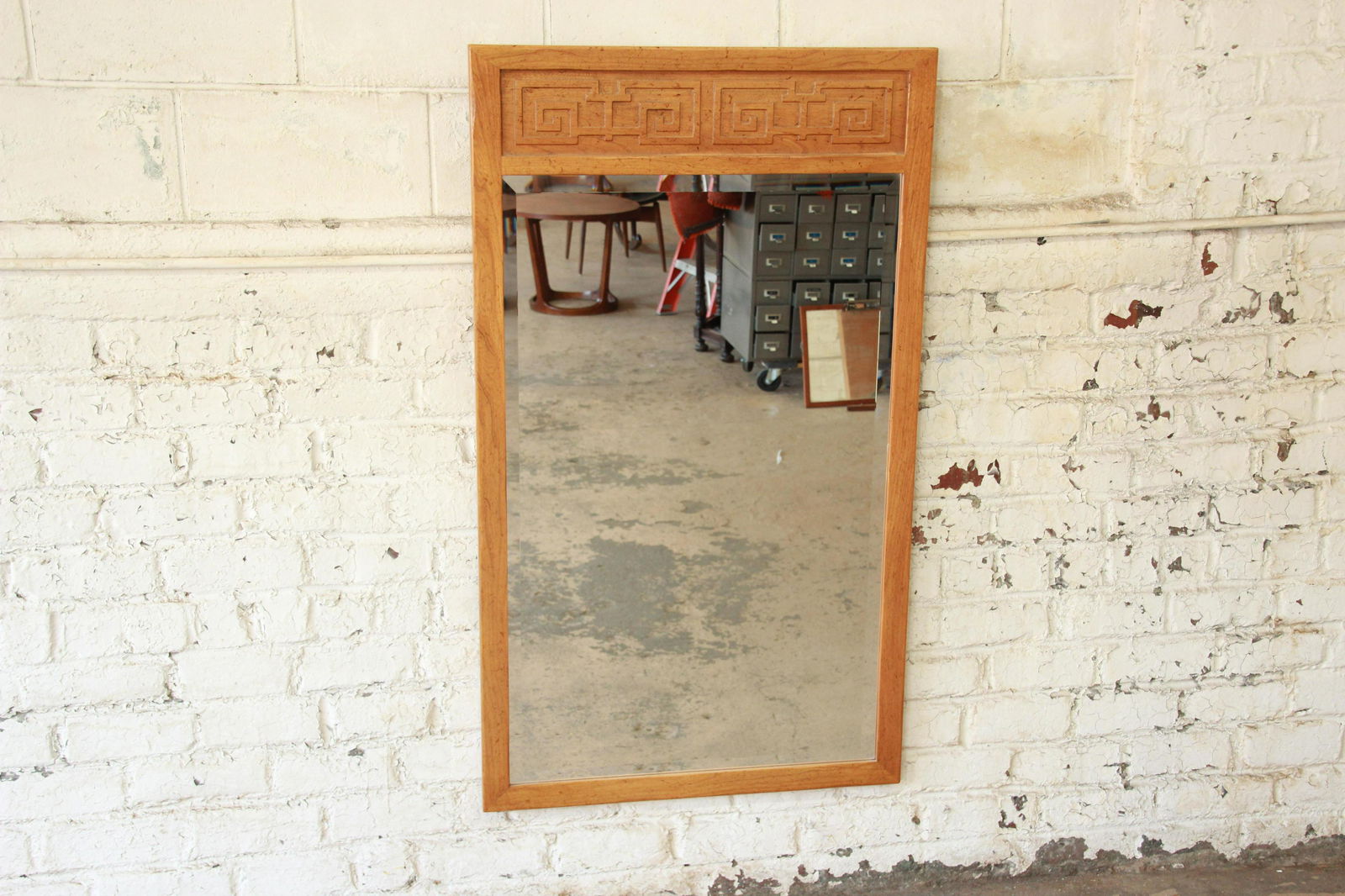 Authentic Michael Taylor for Baker Far East Collection: Offering a stunning Hollywood Regency Chinoiserie beveled wall mirror from the Far East Collection by Michael Taylor for Baker Furniture. The mirror features a gorgeous solid elm wood frame with carve