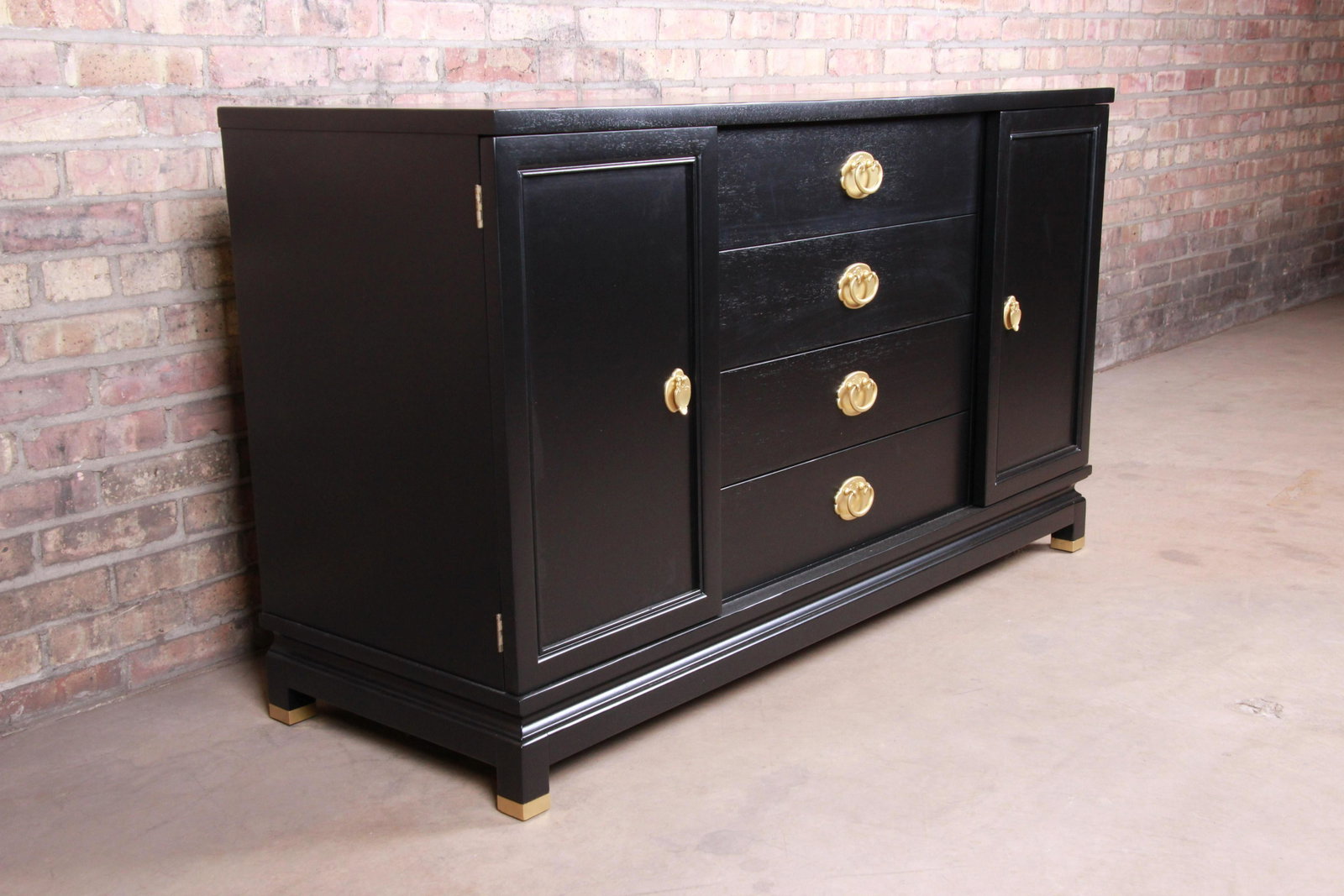 Authentic Merton Gershun for American of Martinsville: An exceptional mid-century Hollywood Regency Chinoiserie sideboard credenza By Merton Gershun for American of Martinsville USA Circa 1960s Black lacquered walnut + Asian-inspired brass hardware and br