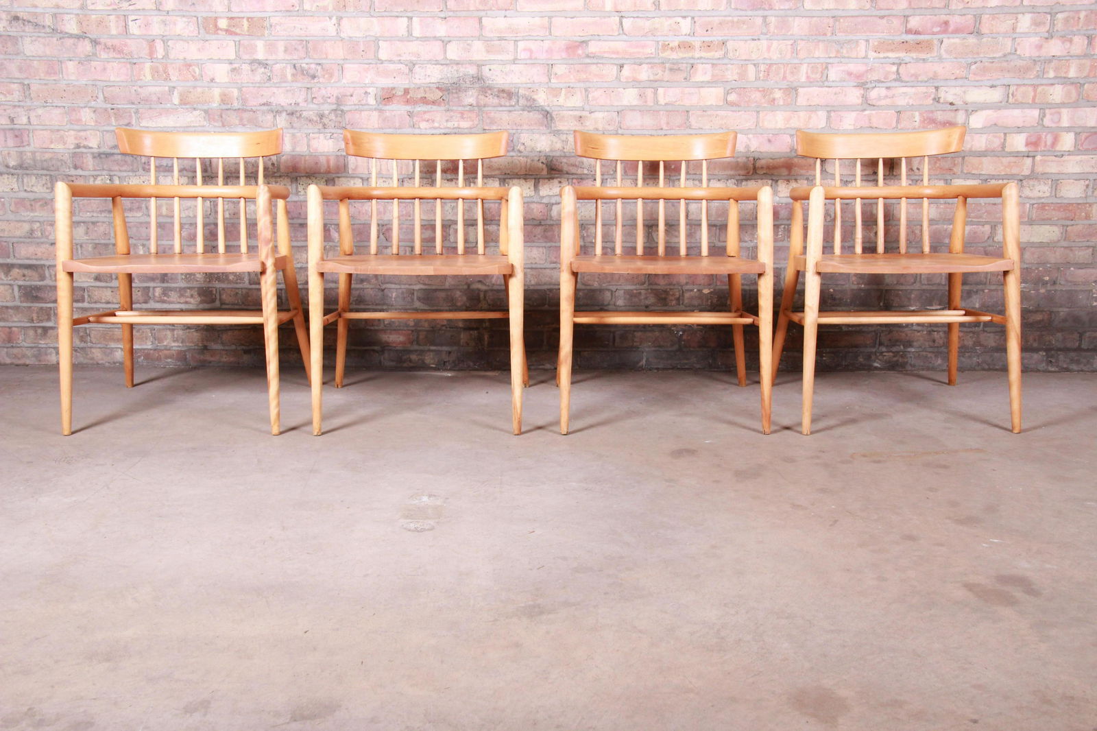 Authentic Paul McCobb Planner Group Solid Maple Spindle: A rare set of four mid-century modern solid maple armchairs By Paul McCobb for Winchendon Furniture "Planner Group" USA 1950s Measures: 21"W x 21.5"D x 29.75"H. Seat height 17.25"; arm height 25.5". V