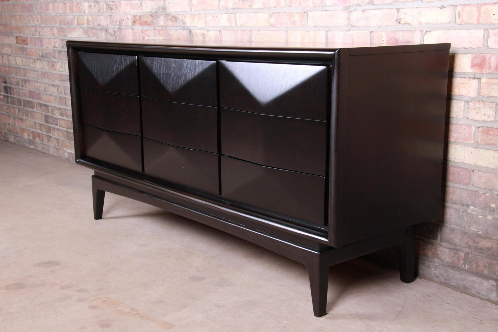 Authentic Mid-Century Modern Ebonized Walnut Diamond: A stunning mid-century modern sculpted walnut ebonized diamond front long dresser or credenza In the manner of Vladimir Kagan By United Furniture Co. USA 1960s Measures: 62"W x 19"D x 30.63"H. Newly r