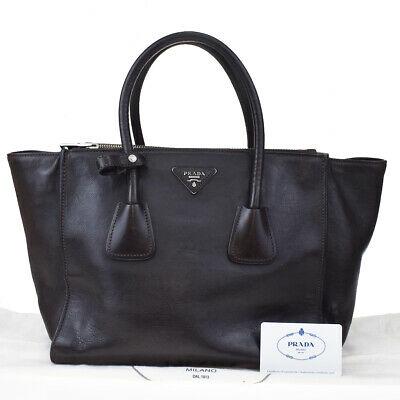Authentic PRADA Hand Bag: Brand: PRADA Model: Hand Bag Country of Origin: Italy Material: Leather Color: Brown Size (Inch): W11.8X H9.4X D7.9"Size (CM): W30X H24X D20Cm All Bidhaus items come with a 100 % money-back authentici
