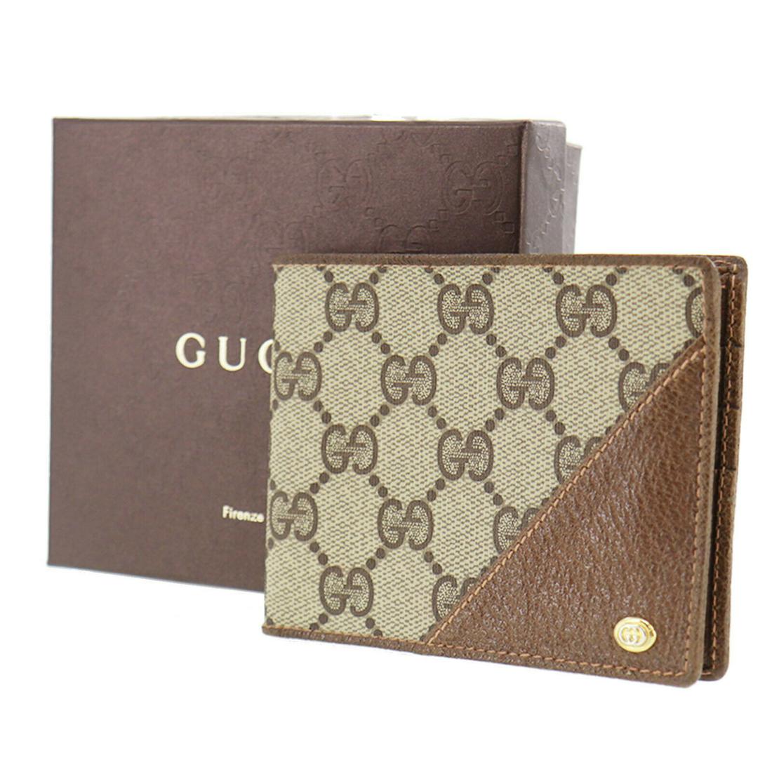 Authentic GUCCI Bi-Fold Wallet: Brand: GUCCI Model: Bi-Fold Wallet Country of Origin: Italy Material: PVC Color: Brown All Bidhaus items come with a 100 % money-back authenticity guarantee. ALL SALES ARE FINAL. Please refer to image