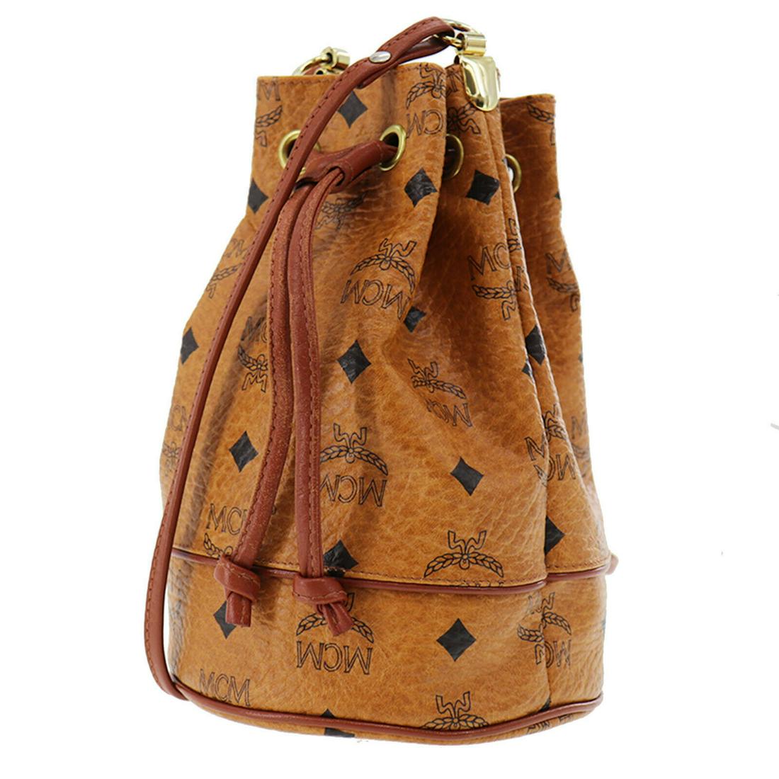 Authentic MCM Shoulder Bag: Brand: MCM Model: Shoulder Bag Country of Origin: Germany Material: Nylon Color: Gold Bag Length: 5.5 Bag Height: 7.8 Bag Depth: 5.5 All Bidhaus items come with a 100 % money-back authenticity guarant