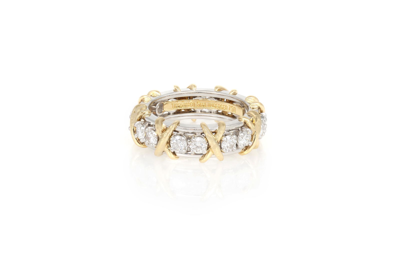 Authentic Tiffany & Co. Sixteen Stone Ring: A Jean Schlumberger creation in which brilliant diamonds alternate with golden X's to create this visionary design. This platinum band ring is composed of 16 round brilliant diamonds and 18K golden X'