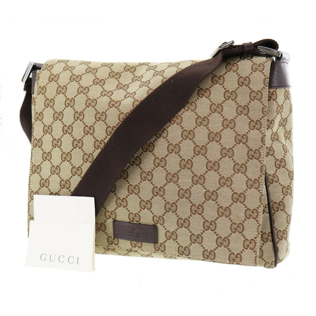 Authentic GUCCI Shoulder Bag: Brand: GUCCI Model: Shoulder Bag Country of Origin: Italy Material: Canvas Color: Black Silver Bag Length: 12.0 Bag Height: 10.2 Bag Depth: 3.1 All Bidhaus items come with a 100 % money-back authentic