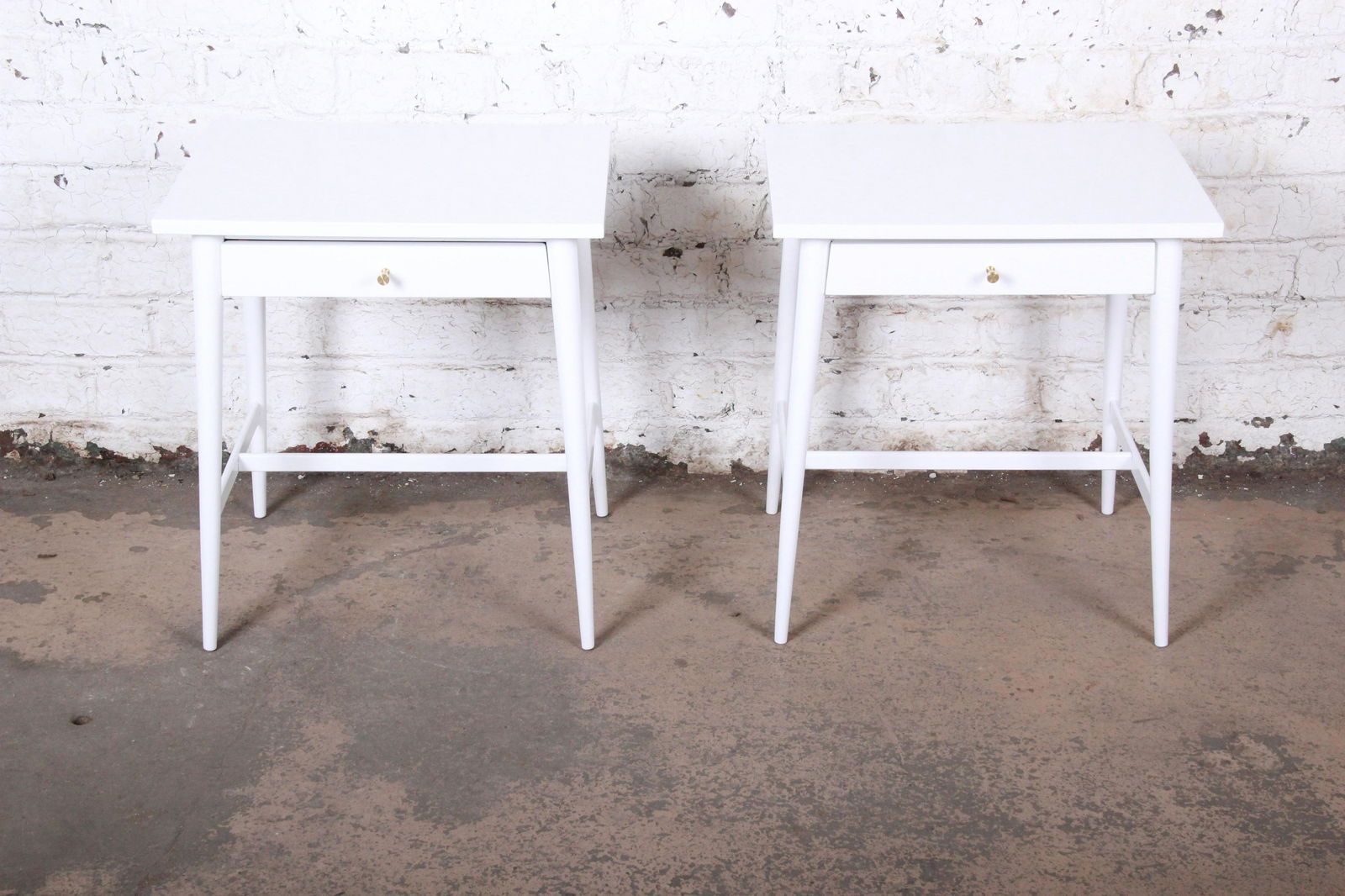 Paul McCobb Planner Group Mid-Century Modern White: An exceptional pair of mid-century modern nightstands Designed by Paul McCobb for Winchendon Furniture "Planner Group" USA 1950s Birch + white lacquer + brass hardware Measures: 22"W x 17"D x 24.13"H.