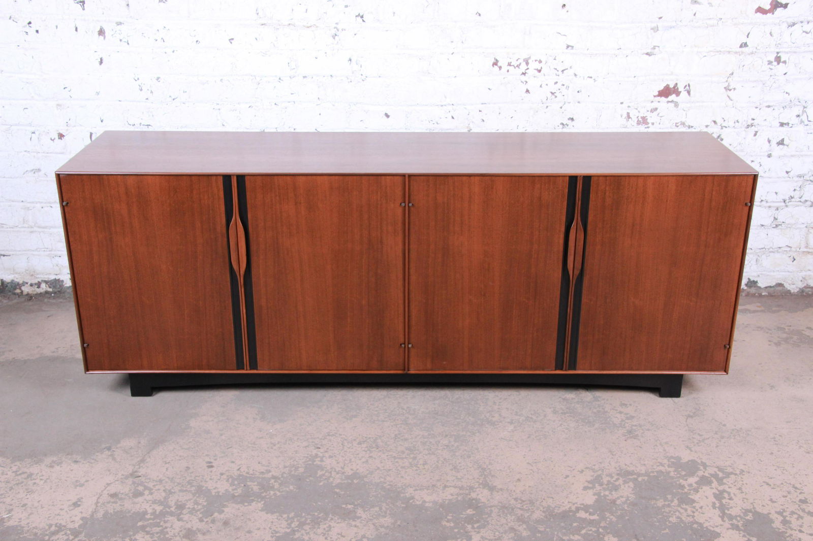 John Kapel for Glenn of California Mid-Century Modern: An exceptional mid-century modern walnut sideboard credenza or bar cabinet Designed by John Kapel for Glenn of California and retailed by John Stuart USA 1960s Walnut + ebonized wood Measures: 80"W x