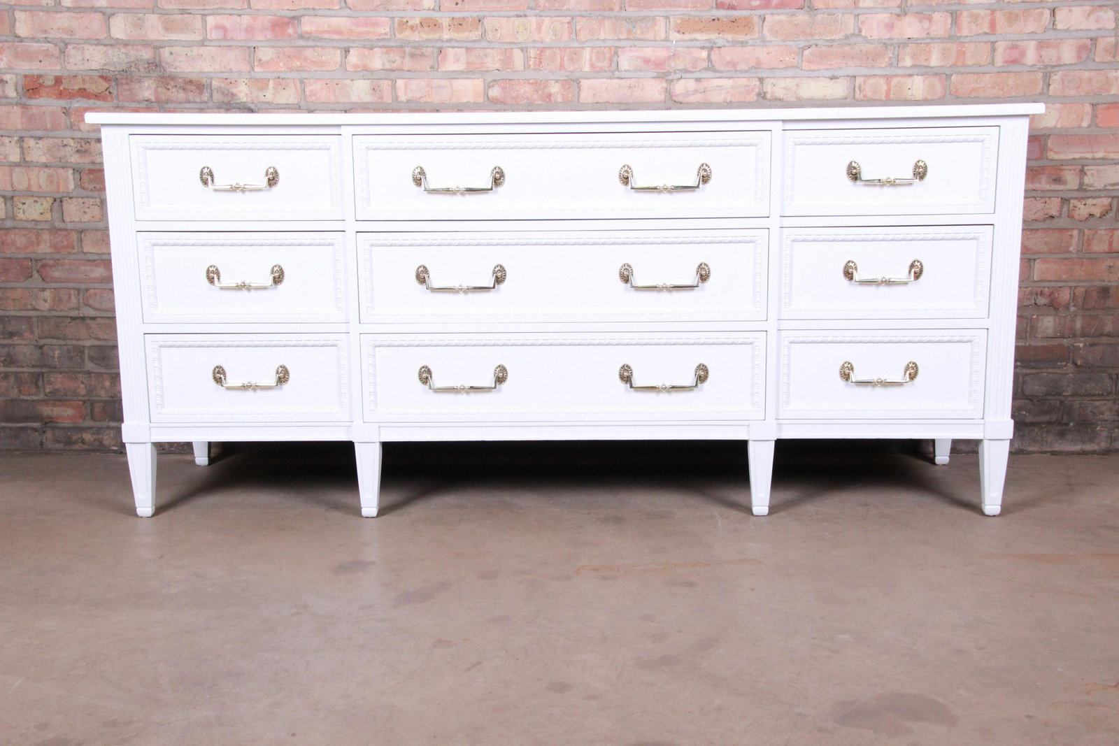 Henredon French Regency Louis XVI White Lacquered: A gorgeous French Regency Louis XVI style long dresser or credenza By Henredon USA Circa 1960s White lacquered walnut with original brass hardware. Measures: 71.75"W x 20.13"D x 32.13"H. Newly refinis