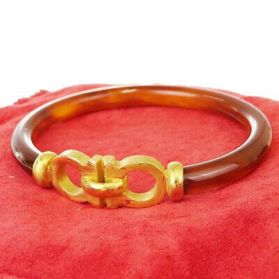 Authentic SALVATORE FERRAGAMO Bracelet: Brand: SALVATORE FERRAGAMO Model: Bracelet Country of Origin: Italy Material: Plastic Gold-Tone Color: Brown Size (Inch): W1.6X H0.4X D0"Size (CM): W4X H1X D0Cm All Bidhaus items come with a 100 % mon