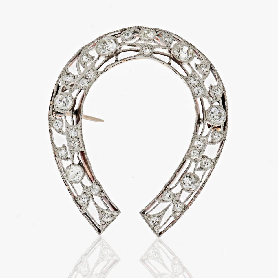 Horseshoe Platinum & 14K Yellow Gold Edwardian Diamond: Type: Vintage Brooches Metal: Platinum & 14K Yellow Gold Grams: 7.8 Exact Diamond Weight: 2.5 Cts Other Details: An Edwardian Diamond & Platinum Antique Horseshoe Brooch of exceptional quality feature