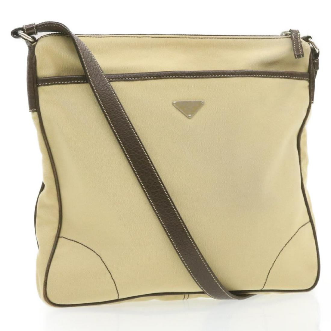 Authentic PRADA Canvas Shoulder Bag: Brand: PRADA Material: Canvas Style: Shoulder Bag Color: Beige Size(inch): W13.38 x H12.99 x D1.57inch / Shoulder Drop 18.11-20.47inch(Approx) Country of Origin: Italy Accessory: There is no item box 