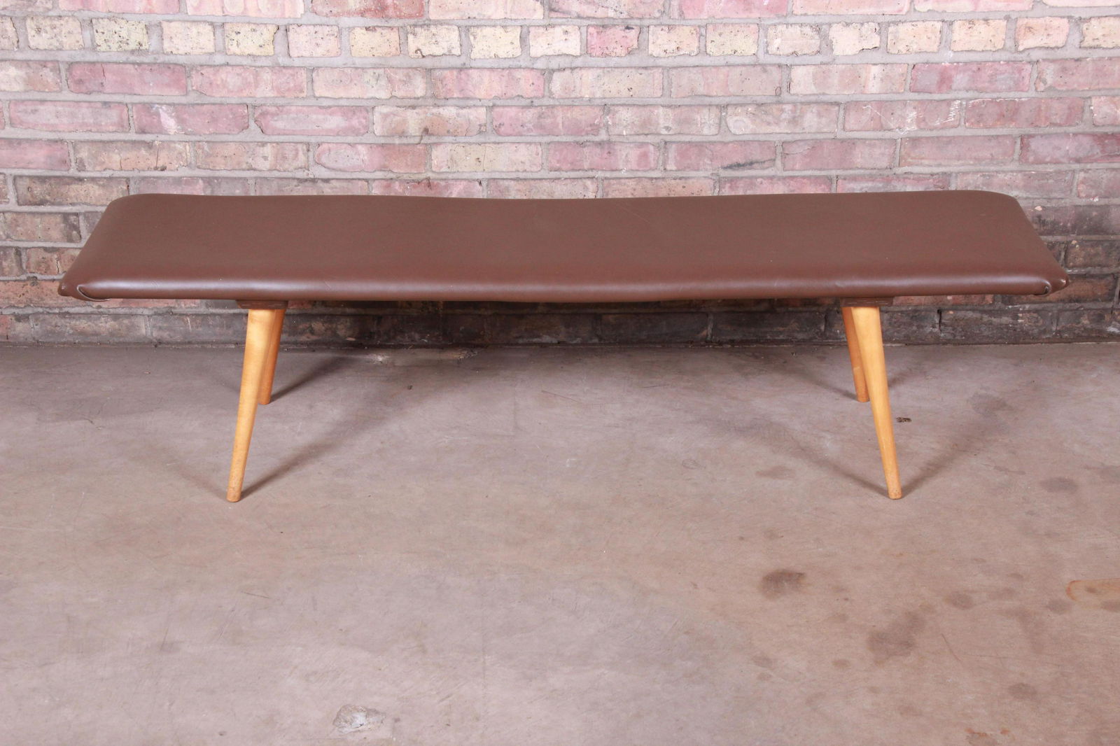 Paul McCobb Planner Group Custom Maple and Leather: A sleek and stylish mid-century modern bench By Paul McCobb for Winchendon Furniture "Planner Group" USA 1950s Solid maple legs + leather-wrapped top Measures: 60.75"W x 16.25"D x 16"H. Very good vint