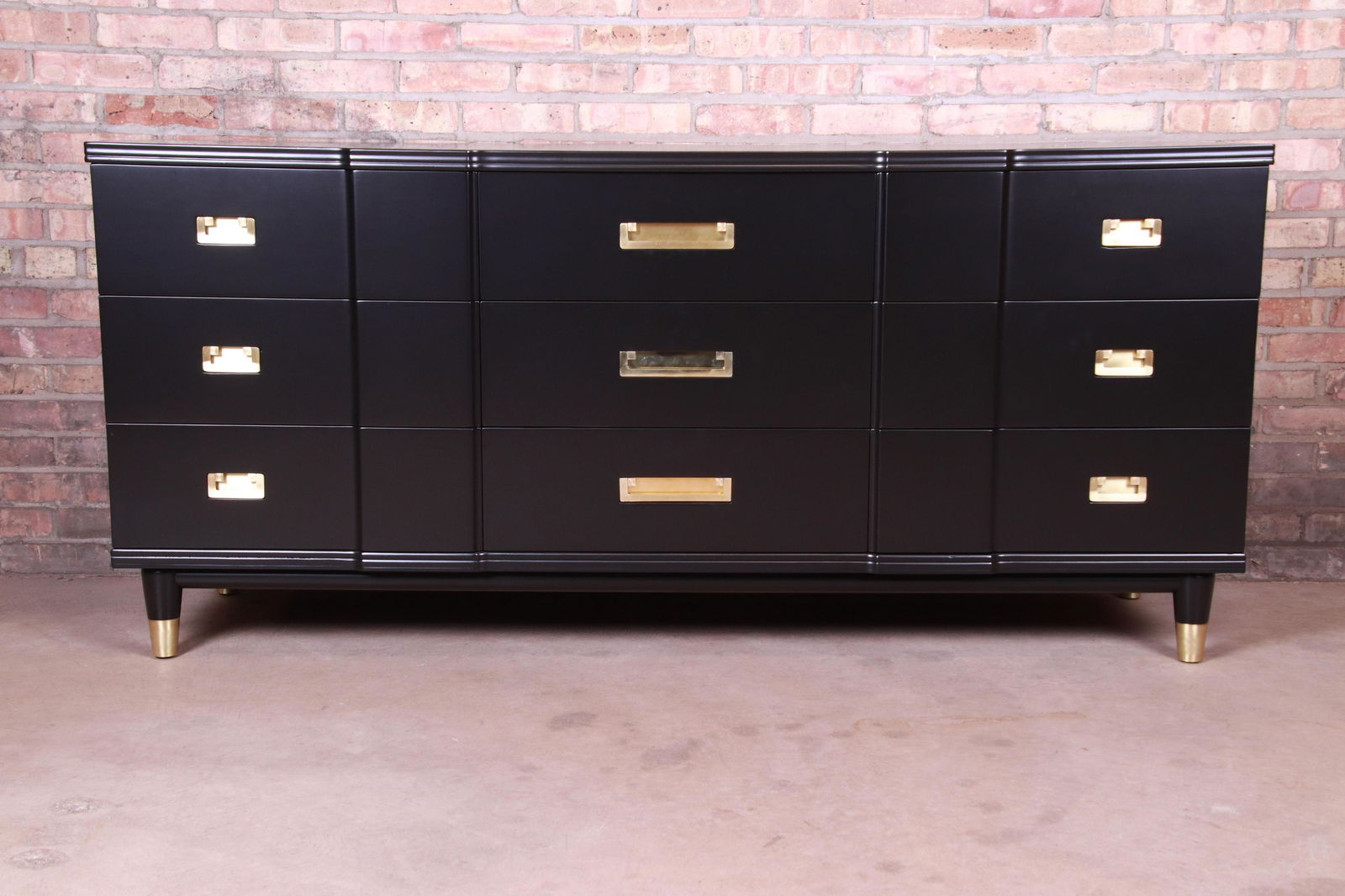 John Widdicomb Mid-Century Modern Hollywood Regency: An exceptional mid-century modern Hollywood Regency Campaign nine-drawer long dresser or credenza By John Widdicomb USA 1950s Black lacquered solid cherry wood with original brass hardware and brass-c