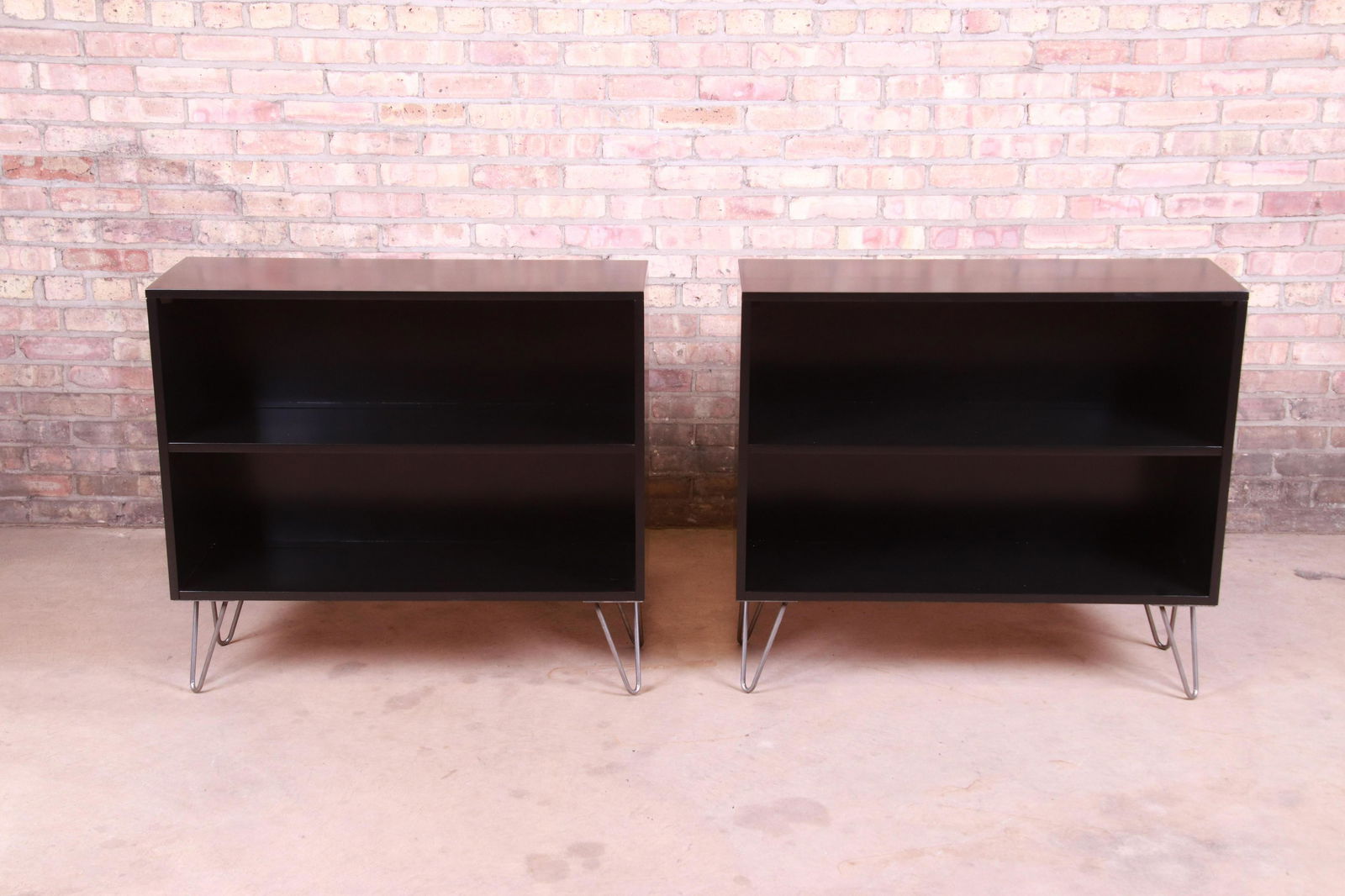 Paul McCobb Planner Group Black Lacquered Bookcases on: An exceptional pair of mid-century modern black lacquered solid birch bookcases on hairpin legs By Paul McCobb for Winchendon Furniture "Planner Group" USA 1950s Measures: 36"W x 12.13"D x 32"H. Newly