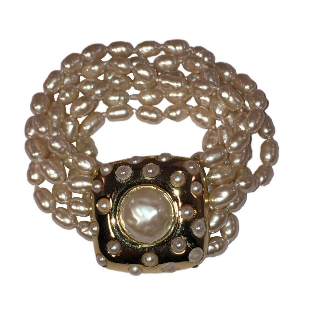 Authentic GIVENCHY Multi Strand Peal Bracelet: Brand: GIVENCHY Givenchy Multi Strand Peal Bracelet Multi Strand18 kt gold electroplated over costume metal with a large unique baroque pearl clasp.Circa 1980sMeasures 7 1/2" long by 1 1/2" wide.Marke