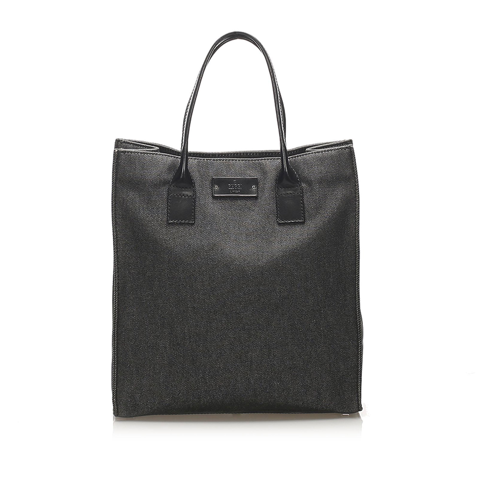 Authentic Gucci Denim Tote Bag: This tote bag features a denim body flat leather straps open top and an interior zip pocket. Brand: Gucci Model: Denim Tote Bag Origin: Italy Category: Tote Bag Color: Black Style: Others Material: Fa