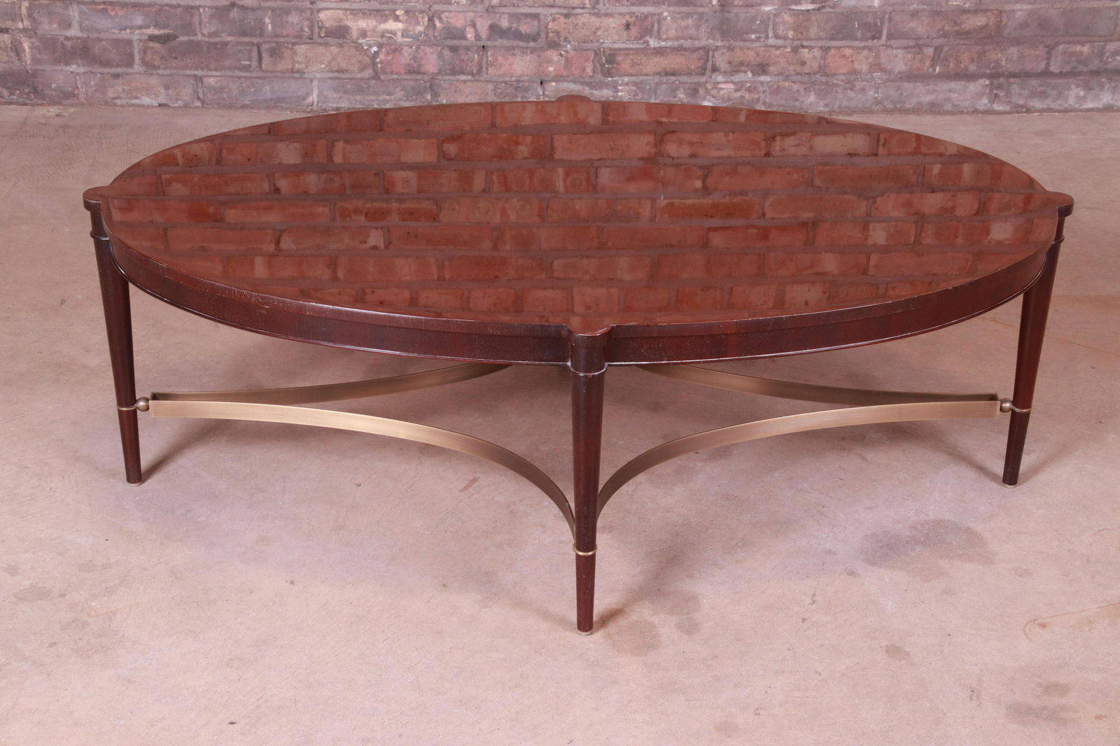Thomas Pheasant for Baker Furniture Mahogany and Brass: A gorgeous contemporary oval coffee or cocktail table By Baker Furniture USA Early 21st Century Mahogany with brass stretchers. Measures: 48.5"W x 30.5"D x 16.38"H. Good original vintage condition. Di