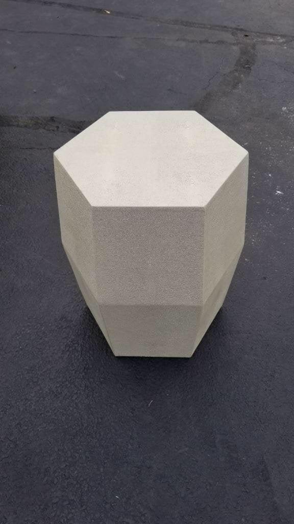 Made Goods Daryl Stool in Off White: Made Goods Daryl Stool in Off White A perfect stool or accent table! The Daryl uses our dramatic faux shagreen. Hexagonal in shape the piece has straight sides that elegantly taper near the top and ba