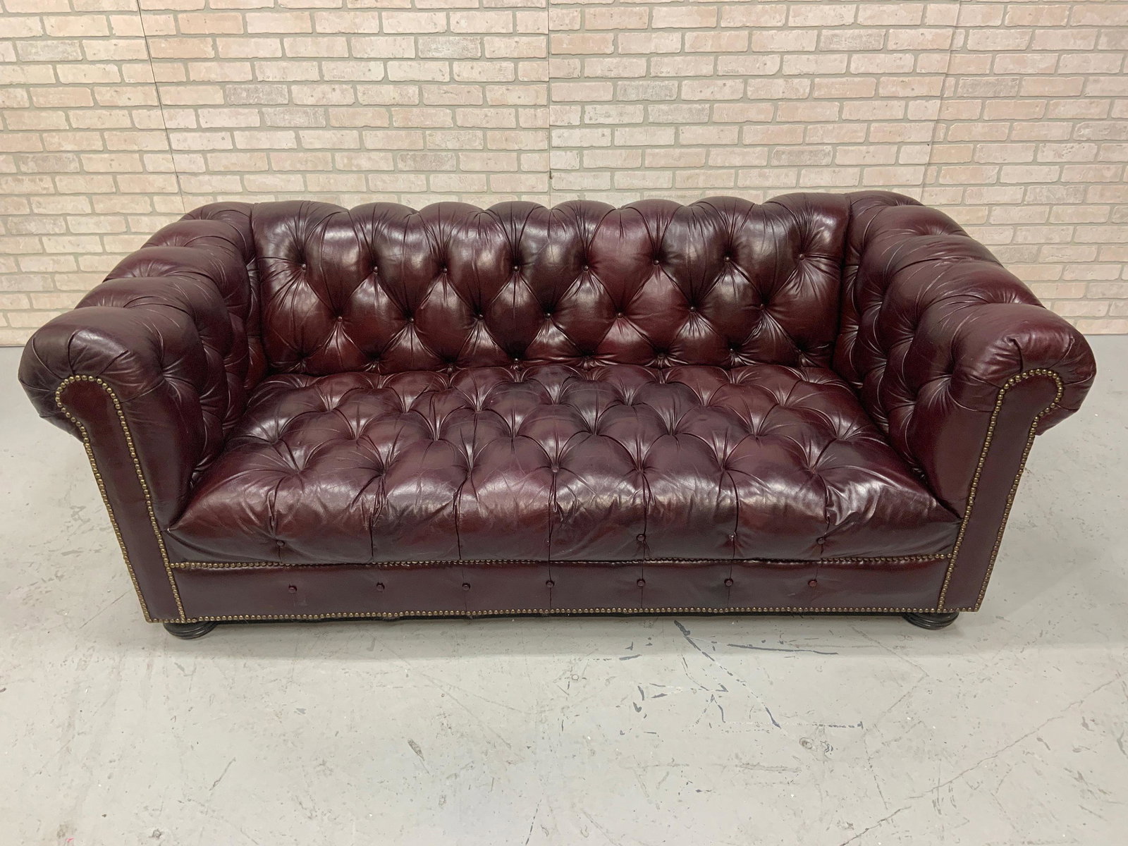 Hancock and Moore Chesterfield Tufted Burgundy Leather: Hancock and Moore Chesterfield Tufted Burgundy Leather Sofa A distinctly elegant Hancock & Moore Fine Furniture burgundy leather Chesterfield sofa with tufted design on seat back and arms. The front p
