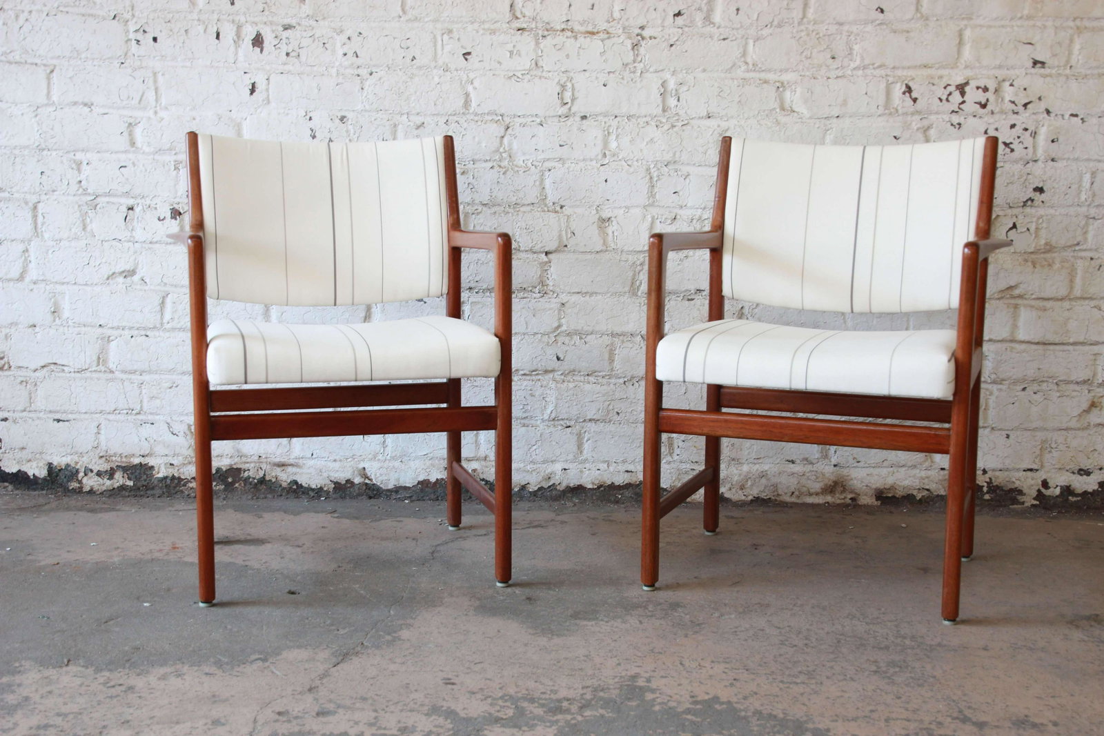 Swedish Modern Solid Teak Arm Chairs by Karl Erik: Offering a very nice pair of Swedish modern solid teak arm chairs by Karl Erik Ekselius. The chairs are made from solid teak with a nice wide frame and arm rest for added comfort. The upholstery is cl