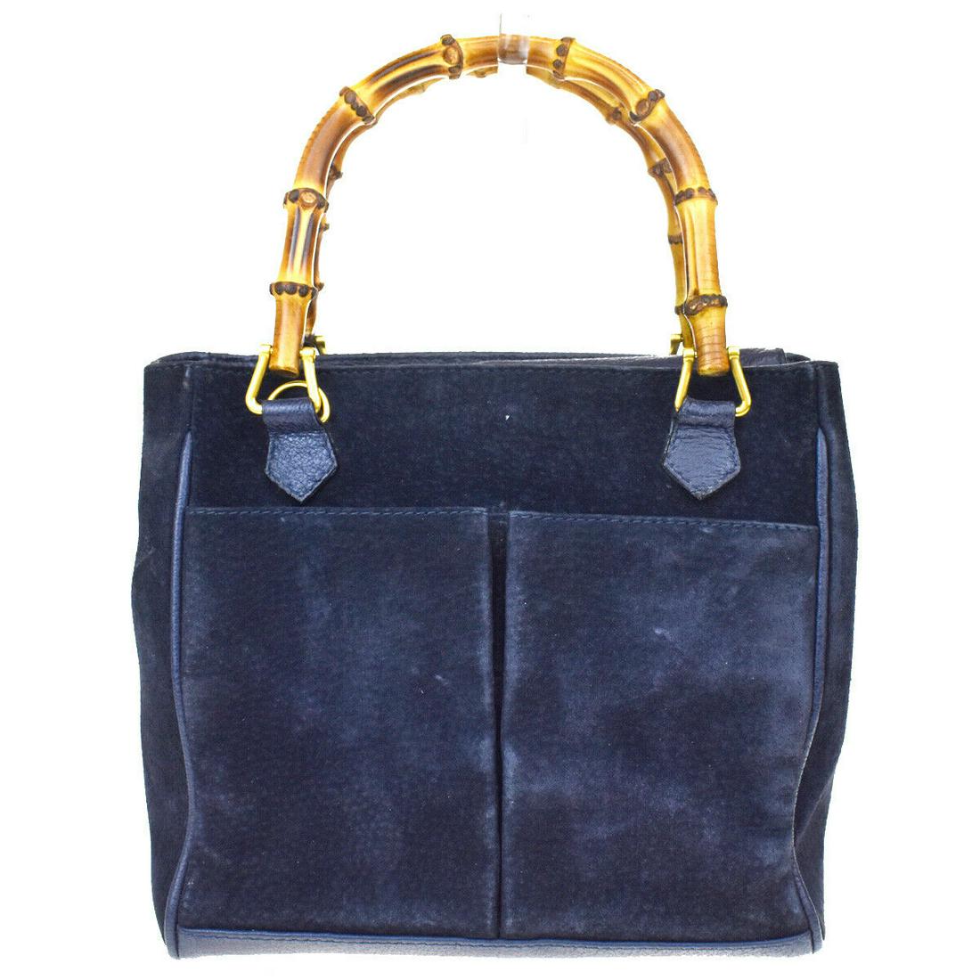 Authentic GUCCI Hand Bag: Brand: GUCCI Model: Hand Bag Country of Origin: Italy Material: Suede Leather Color: Navy Blue Size (Inch): W7.9X H7.5X D4.7"Size (CM): W20X H19X D12Cm All Bidhaus items come with a 100 % money-back a