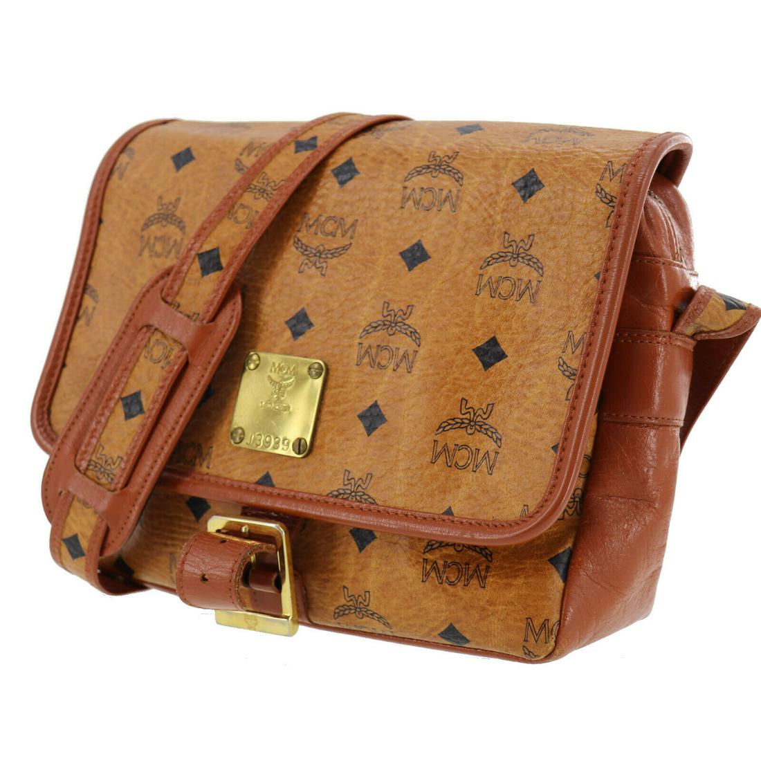 Authentic MCM Shoulder Bag: Brand: MCM Model: Shoulder Bag Country of Origin: Germany Material: Leather Color: Gold Bag Length: 8.6 Bag Height: 7.0 Bag Depth: 3.1 All Bidhaus items come with a 100 % money-back authenticity guara