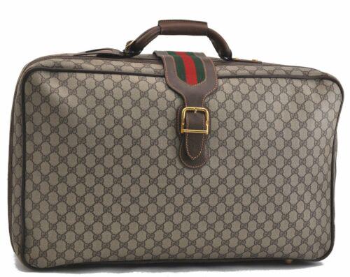 Authentic GUCCI Travel Bag: Brand: GUCCI Model: Travel Bag Country of Origin: Italy Material: PVC Color: Brown Bag Length: 23.2inches (59cm) Bag Height: 14inches (35.5cm) Bag Depth: 7.5inches (19cm) All Bidhaus items come with a