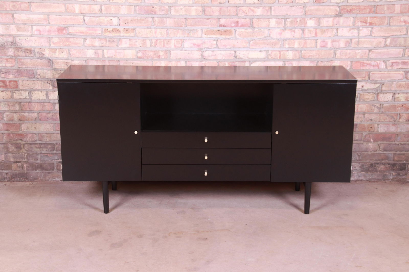 Paul McCobb Planner Group Black Lacquered Credenza or: An exceptional mid-century modern sideboard credenza or media cabinet By Paul McCobb for Winchendon Furniture "Planner Group" USA 1950s Black lacquered solid birch with original brass hardware. Measur