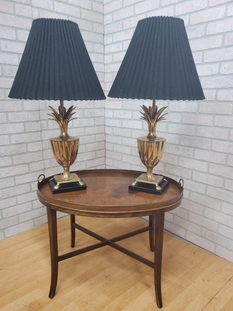 Hollywood Regency Frederick Cooper Brass Pineapple: Hollywood Regency Frederick Cooper Brass Pineapple Table Lamps with Black Shades - Pair The lamps feature a pineapple motif top and fluted urn shaped body with claw feet on plinth base. Pineapple is a